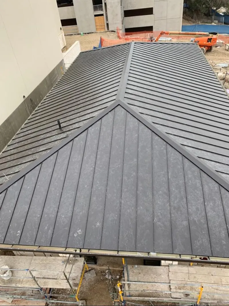 Commercial metal roof construction with crane equipment in Mount Washington